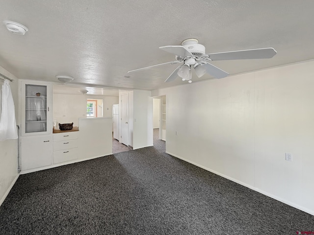 135 N 4th St, Hotchkiss, CO 81419 - unfurnished living room with ceiling fan, baseboards, and a textured ceiling