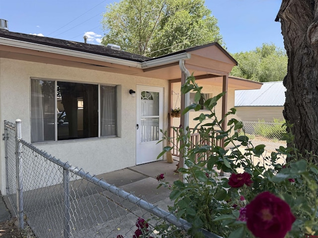 135 N 4th St, Hotchkiss, CO 81419 - entrance to property featuring stucco siding and a patio area