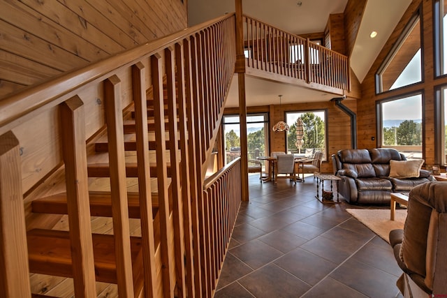 76 Pinnacle Dr, Ridgway, CO 81432 - stairway featuring high vaulted ceiling, tile patterned flooring, and wood walls