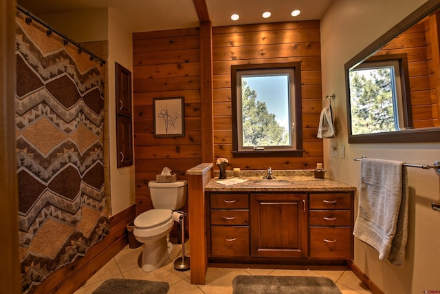 76 Pinnacle Dr, Ridgway, CO 81432 - bathroom with toilet, vanity, tile patterned flooring, wooden walls, and a shower with shower curtain