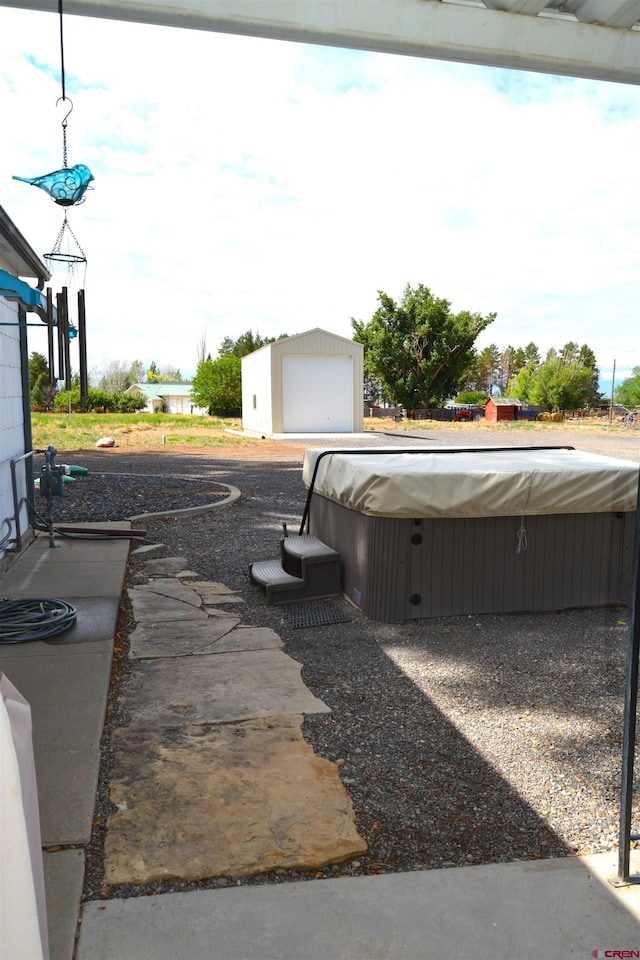 8801 2100th Rd, Austin, CO 81410 - view of patio with a detached garage and a hot tub