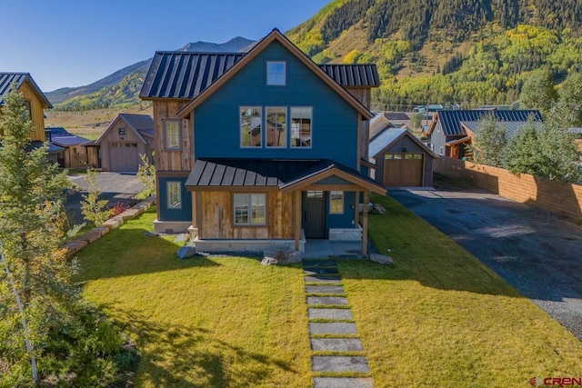 918 Belleview Ave, Crested Butte, CO 81224 - view of front of house with a standing seam roof, metal roof, driveway, and a mountain view