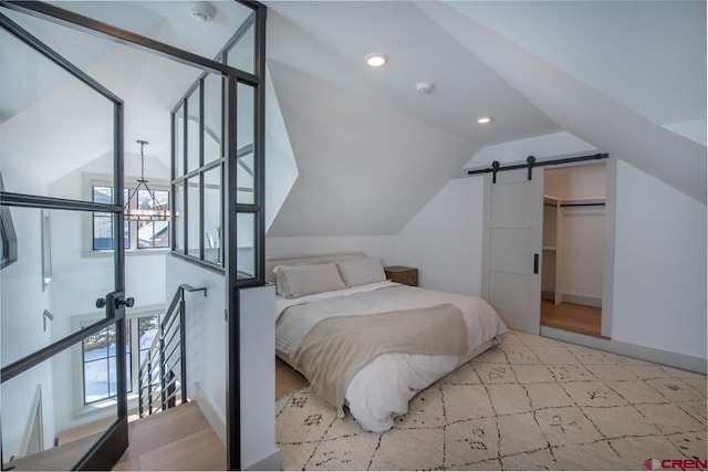 918 Belleview Ave, Crested Butte, CO 81224 - bedroom featuring vaulted ceiling, a barn door, and recessed lighting