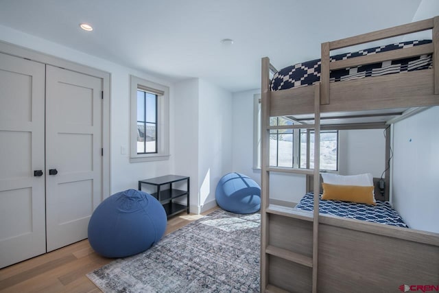 918 Belleview Ave, Crested Butte, CO 81224 - bedroom featuring wood finished floors, multiple windows, a closet, and recessed lighting