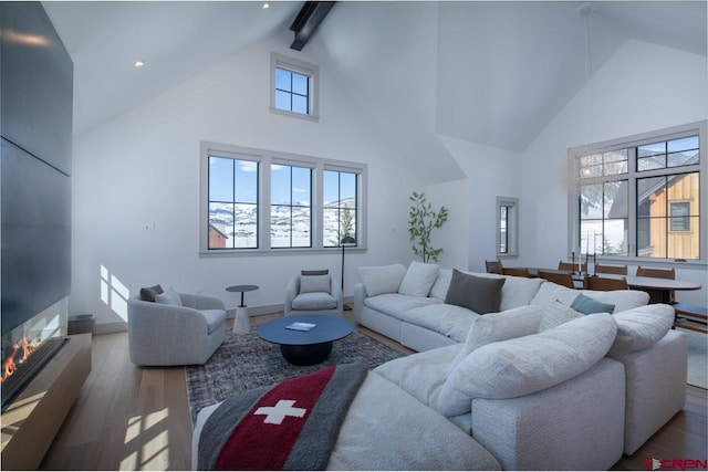 918 Belleview Ave, Crested Butte, CO 81224 - living area featuring high vaulted ceiling, wood finished floors, beam ceiling, and recessed lighting