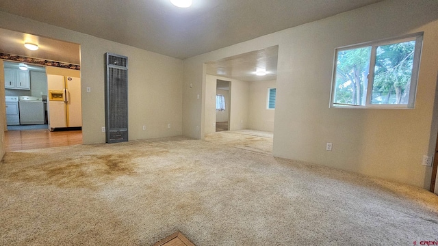 1551 G86 Rd, Delta, CO 81416 - spare room featuring a heating unit, independent washer and dryer, and light carpet