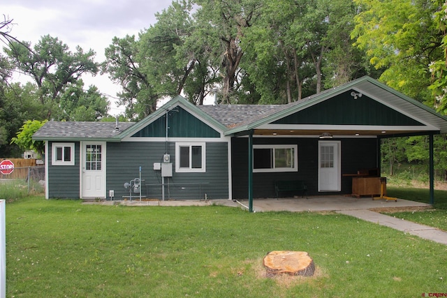1551 G86 Rd, Delta, CO 81416 - rear view of property featuring a lawn, a patio area, a shingled roof, and a chimney