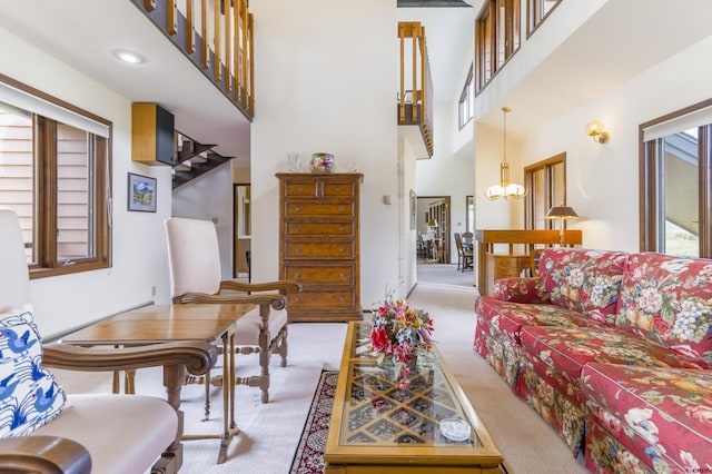 42246 US Highway 50, Gunnison, CO 81230 - living area with light colored carpet, a high ceiling, and a chandelier