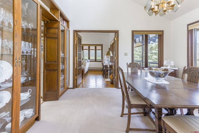 42246 US Highway 50, Gunnison, CO 81230 - carpeted dining area featuring a chandelier, healthy amount of natural light, high vaulted ceiling, and a baseboard radiator