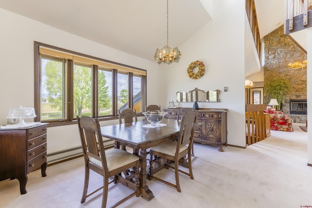 42246 US Highway 50, Gunnison, CO 81230 - dining space with a chandelier, light carpet, high vaulted ceiling, and a baseboard heating unit