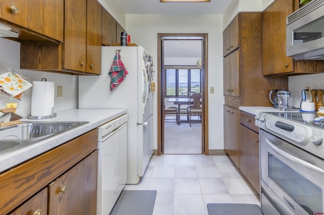 42246 US Highway 50, Gunnison, CO 81230 - kitchen with stainless steel appliances, light countertops, and brown cabinets