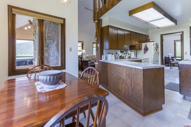 42246 US Highway 50, Gunnison, CO 81230 - kitchen featuring freestanding refrigerator, light countertops, and a peninsula