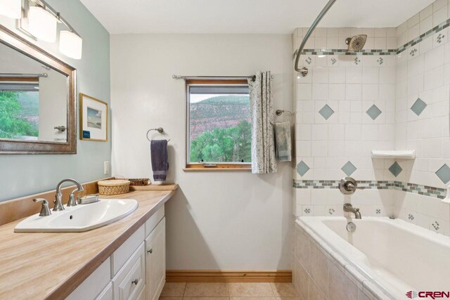 280 Marys Rd, Ridgway, CO 81432 - bathroom featuring vanity, tile patterned flooring, baseboards, and tiled shower / bath