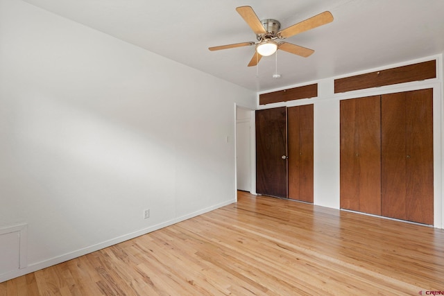 2224 Crestview Dr, Durango, CO 81301 - unfurnished bedroom featuring light wood-type flooring, two closets, baseboards, and a ceiling fan