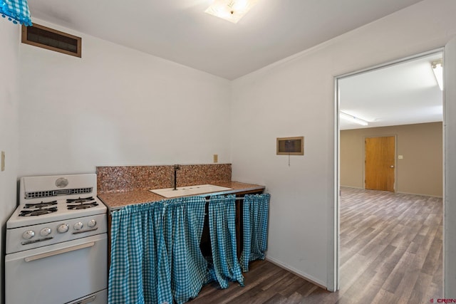 2224 Crestview Dr, Durango, CO 81301 - kitchen with white gas range oven, a sink, wood finished floors, and baseboards