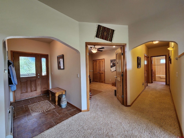 421 Elk Meadow Run, Antonito, CO 81120 - carpeted foyer entrance with arched walkways, a ceiling fan, and baseboards