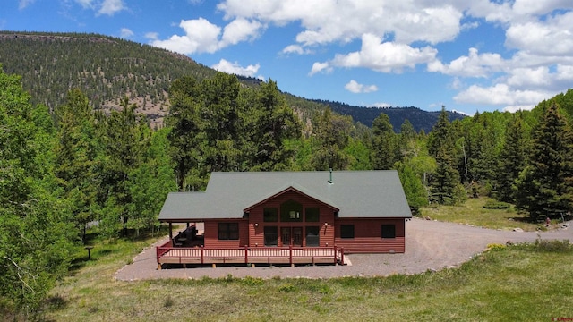 421 Elk Meadow Run, Antonito, CO 81120 - rear view of property with a view of trees and a deck with mountain view