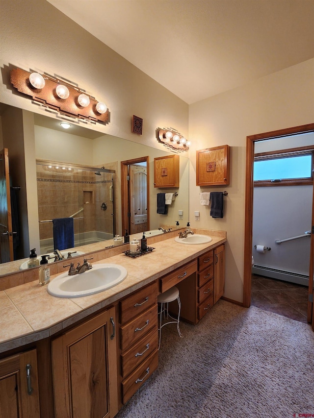 421 Elk Meadow Run, Antonito, CO 81120 - full bathroom featuring baseboard heating, a tile shower, and double vanity