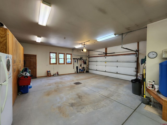 421 Elk Meadow Run, Antonito, CO 81120 - garage featuring freestanding refrigerator and a garage door opener
