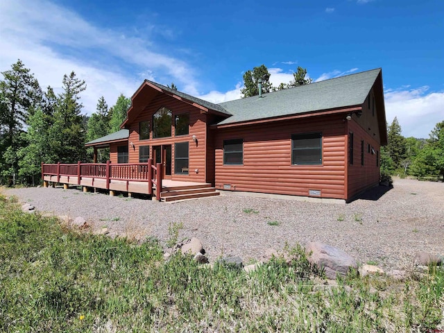 421 Elk Meadow Run, Antonito, CO 81120 - view of front of property featuring a deck, log veneer siding, and a shingled roof