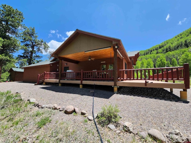 421 Elk Meadow Run, Antonito, CO 81120 - view of front of home with a wooden deck, a ceiling fan, and a wooded view