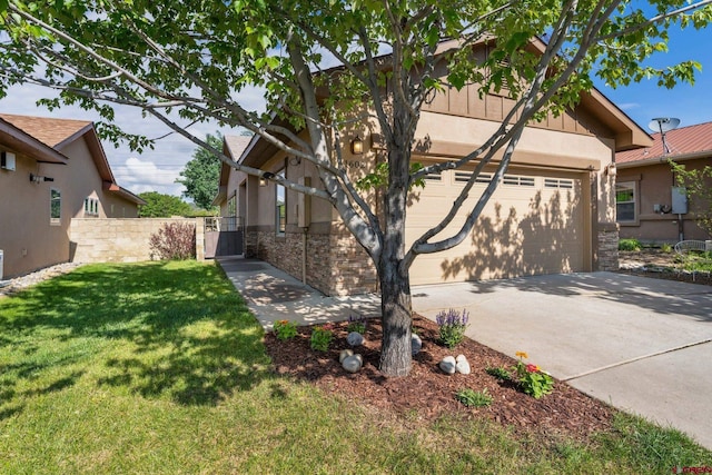 1602 S Taylor Cir, Bayfield, CO 81122 - view of side of home featuring stone siding, concrete driveway, a lawn, stucco siding, and an attached garage