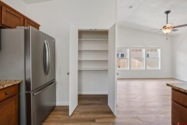 1602 S Taylor Cir, Bayfield, CO 81122 - kitchen featuring freestanding refrigerator, ceiling fan, dark wood-style floors, stone countertops, and a textured ceiling