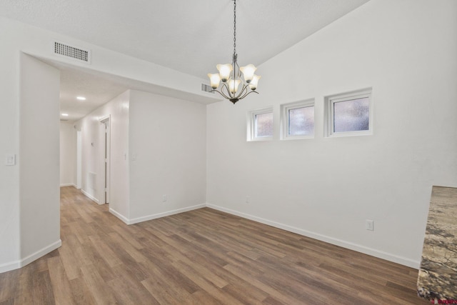 1602 S Taylor Cir, Bayfield, CO 81122 - spare room featuring wood finished floors, a chandelier, and baseboards