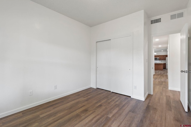 1602 S Taylor Cir, Bayfield, CO 81122 - unfurnished bedroom with wood finished floors, baseboards, and a closet