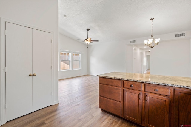 1602 S Taylor Cir, Bayfield, CO 81122 - kitchen with ceiling fan, a textured ceiling, light wood finished floors, a chandelier, and vaulted ceiling