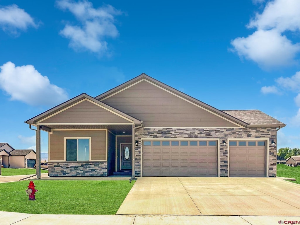 LOT1BLK18 Fivemile Creek Ave, Montrose, CO 81401 - view of front of property with an attached garage, concrete driveway, a front yard, stone siding, and covered porch