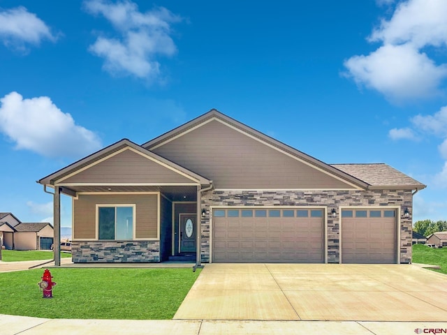 LOT1BLK18 Fivemile Creek Ave, Montrose, CO 81401 - view of front of property with an attached garage, concrete driveway, a front yard, stone siding, and covered porch