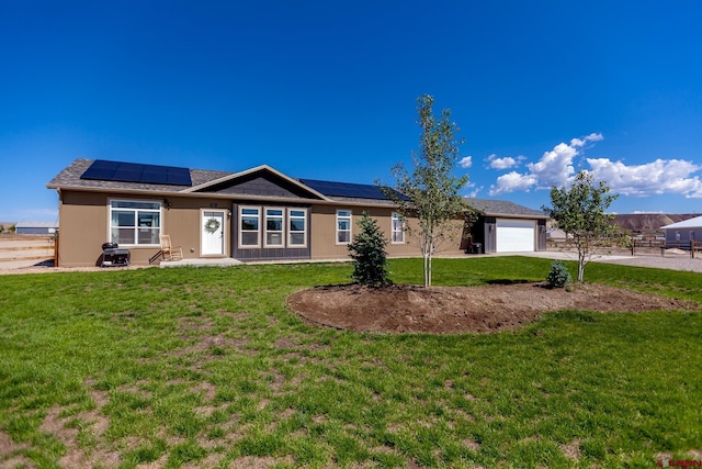 729 Spotted Pony Ct, Delta, CO 81416 - ranch-style house with an attached garage, driveway, and roof mounted solar panels