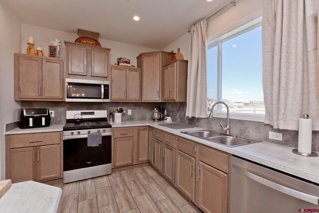 729 Spotted Pony Ct, Delta, CO 81416 - kitchen with appliances with stainless steel finishes, a sink, light countertops, decorative backsplash, and recessed lighting