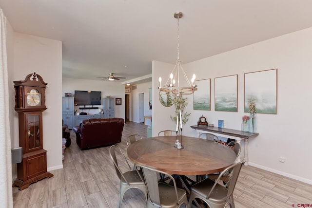 729 Spotted Pony Ct, Delta, CO 81416 - dining area with a chandelier, light wood finished floors, baseboards, and ceiling fan