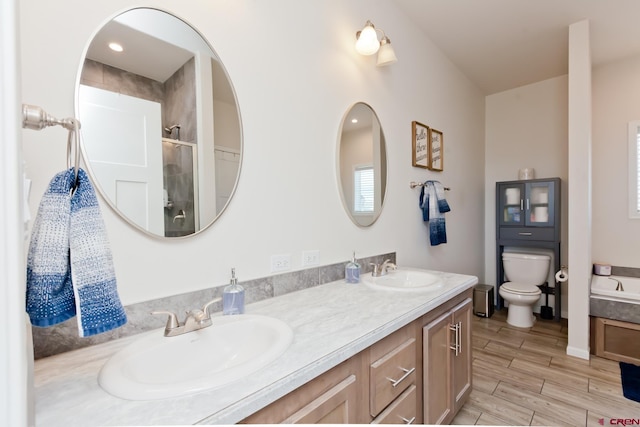 729 Spotted Pony Ct, Delta, CO 81416 - full bath featuring double vanity, toilet, a shower with shower door, and wood finish floors