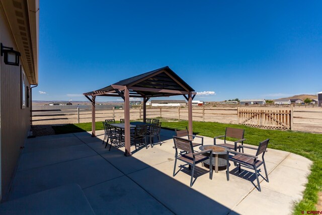 729 Spotted Pony Ct, Delta, CO 81416 - fenced backyard with an outdoor fire pit, a gazebo, a patio, and outdoor dining space