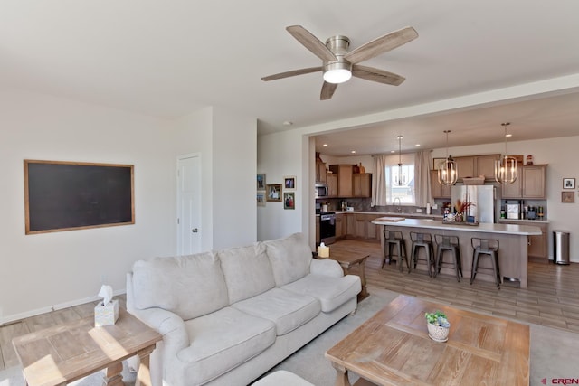 729 Spotted Pony Ct, Delta, CO 81416 - living room with a chandelier, a ceiling fan, and light wood-type flooring