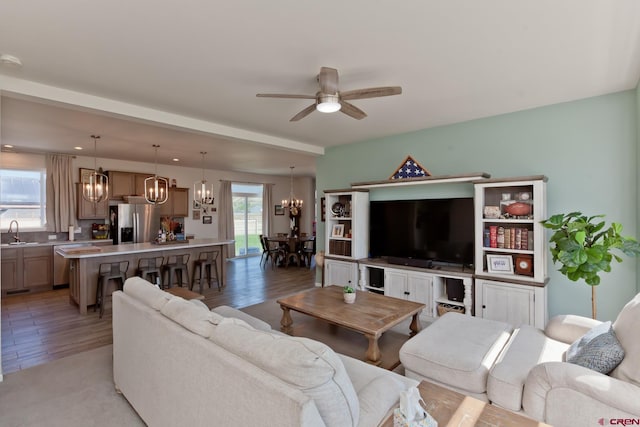 729 Spotted Pony Ct, Delta, CO 81416 - living area with a chandelier, a ceiling fan, and light wood finished floors