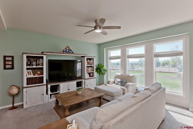 729 Spotted Pony Ct, Delta, CO 81416 - living room with a ceiling fan, baseboards, plenty of natural light, and light colored carpet