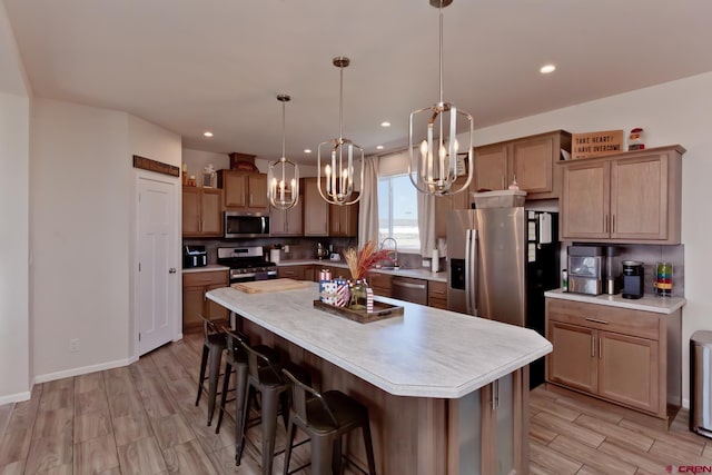 729 Spotted Pony Ct, Delta, CO 81416 - kitchen featuring appliances with stainless steel finishes, a chandelier, light countertops, light wood-type flooring, and a sink