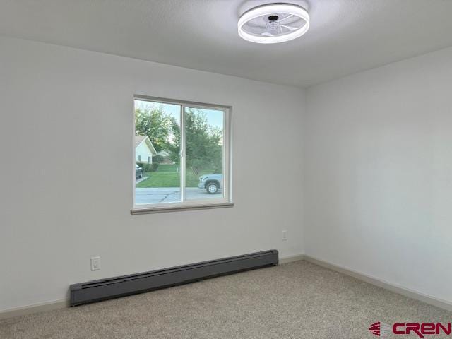 2149 Hartord Way Unit A, Montrose, CO 81401 - spare room featuring a baseboard radiator, carpet floors, and baseboards