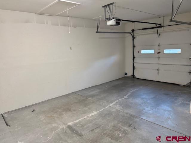2149 Hartord Way Unit A, Montrose, CO 81401 - garage featuring a garage door opener