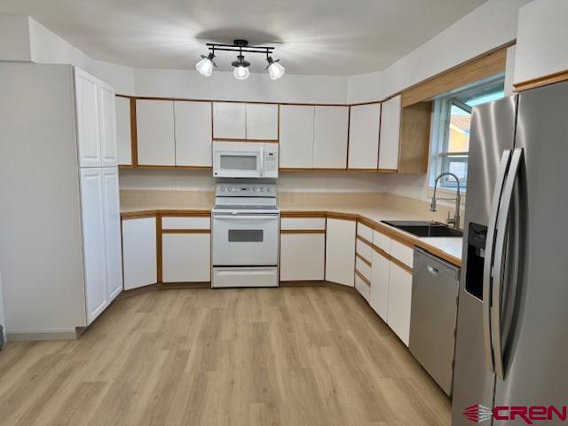 2149 Hartord Way Unit A, Montrose, CO 81401 - kitchen featuring stainless steel appliances, a sink, white cabinetry, and light countertops