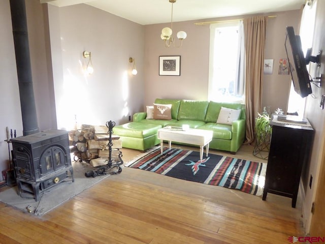1572 Greene St, Silverton, CO 81433 - living area featuring hardwood / wood-style flooring, a wood stove, and a chandelier