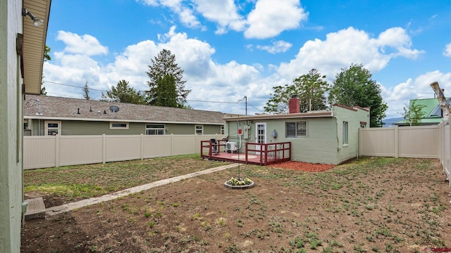 355 NW 5th St, Cedaredge, CO 81413 - rear view of property featuring a fenced backyard, a wooden deck, and a chimney