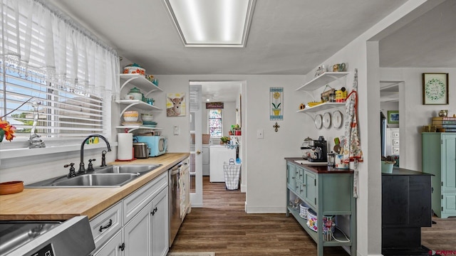355 NW 5th St, Cedaredge, CO 81413 - kitchen with open shelves, washing machine and dryer, wooden counters, and dark wood-style floors