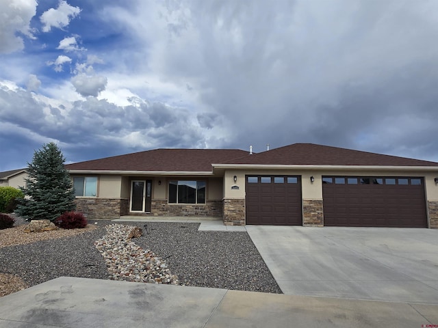 1285 Peppertree Dr, Montrose, CO 81401 - prairie-style home with stucco siding, a garage, and stone siding