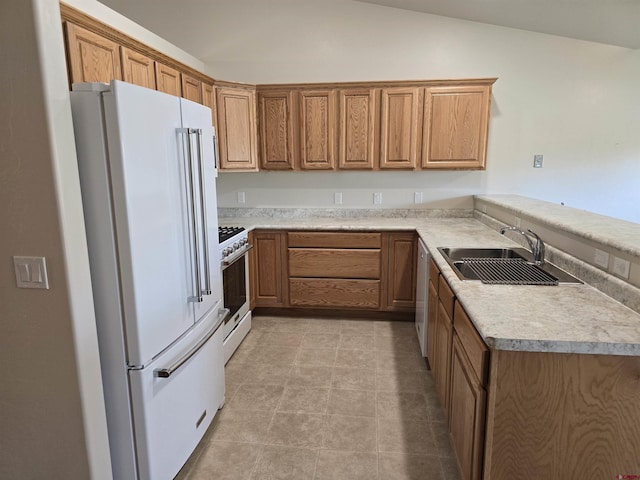 1285 Peppertree Dr, Montrose, CO 81401 - kitchen with white appliances, vaulted ceiling, light countertops, and brown cabinets