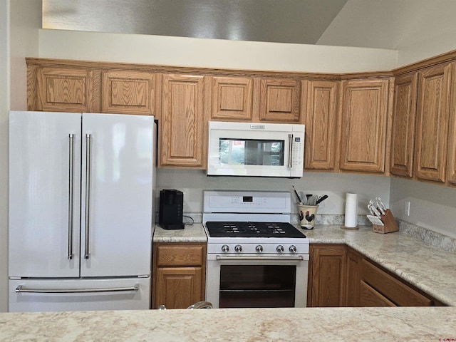 1285 Peppertree Dr, Montrose, CO 81401 - kitchen with white appliances, light countertops, and brown cabinetry